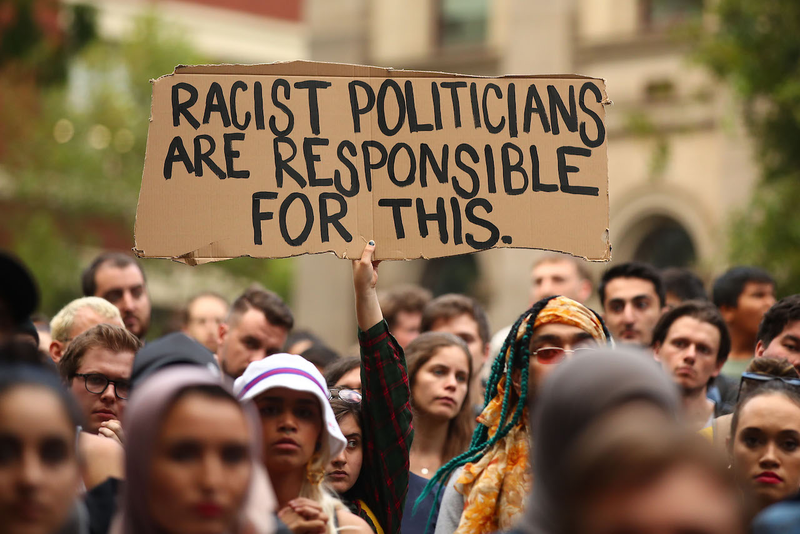 Protesters hold placards as they march during the Stand Against Racism and Islamophobia: Fraser Anning Resign! rally on March 19, 2019 in Melbourne, Australia.